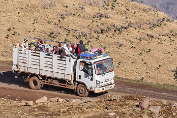 Image showing People traveling dangerously on truck