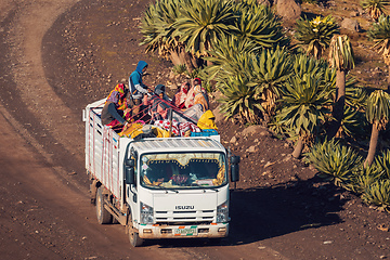 Image showing People traveling dangerously on truck