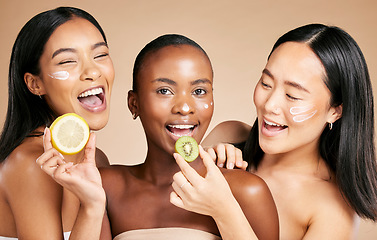 Image showing Happy woman, friends and fruit for healthy skincare, nutrition or vitamin C and facial moisturizer against studio background. Portrait of female models with smile holding organic food for health diet