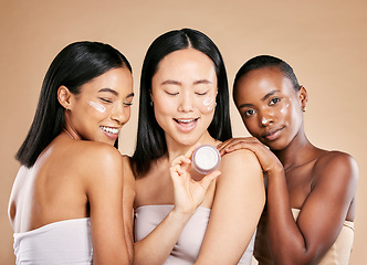 Image showing Woman, skincare and face cream product in studio for wellness, skin and grooming on brown background. Facial, mask and friends relax for beauty, sunscreen and lotion, luxury and pamper while isolated