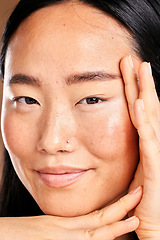 Image showing Closeup portrait, hand frame and asian woman in studio with skincare, natural skin glow and smile. Happy japanese model, cosmetic beauty and healthy aesthetic with self care, wellness and headshot