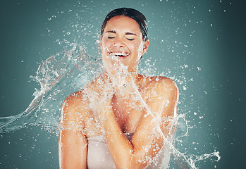 Image showing Skincare, woman and water splash for cleaning, shower and hygiene on studio background. Female person, girl and washing for body care, hydration and wet for grooming routine, liquid and natural care