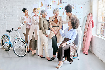 Image showing Fashion, designer and teamwork of women laughing at funny joke, comedy or crazy meme in workshop. Group collaboration, small business or comic senior female tailors together in boutique in discussion