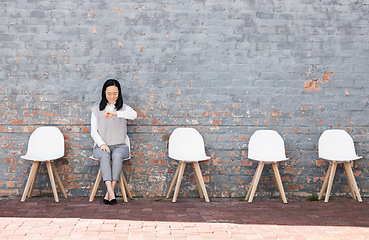 Image showing Waiting, interview and woman check time for recruitment, job opportunity and human resources feedback. Asian person alone on chair looking at watch for career news, feedback and appointment schedule