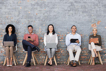 Image showing Diversity, Interview and relax business people line with technology for meeting, recruitment or company hiring. Human resources, employees happy and working on laptop, tablet or smartphone in studio