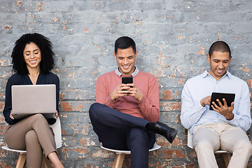 Image showing Interview, human resources or technology with business people waiting in line, using a laptop, phone and tablet. Social media, office and hiring with a man and woman employee group sitting in a row