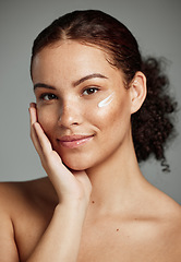 Image showing Face portrait, skincare and woman with cream in studio isolated on a gray background. Cosmetics, beauty and young female model with lotion product, creme or moisturizer for healthy skin and wellness.