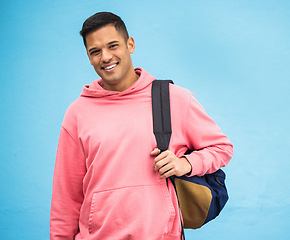 Image showing University, student and portrait of man with backpack in studio, happy and smile on blue background. Face, handsome and college student excited about education, vision and career goal while isolated