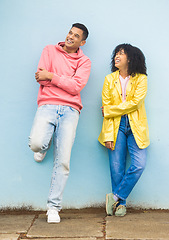 Image showing Black couple, smile and casual fashion standing in urban town wall background for conversation, peace and relax together. Cool man, trendy woman and happy speaking for gen z millennial street style