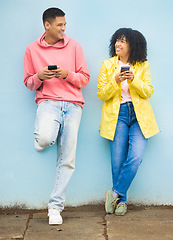 Image showing Happy friends, phone and smile leaning on a wall enjoying social media, conversation or communication in the outdoors. Man and woman smiling for networking, 5G connection or chat on mobile smartphone