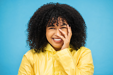 Image showing Portrait, laugh and funny with a black woman on a blue background, laughing at a joke in studio. Face, happy and smile with an attractive young afro woman enjoying humor or fun against a color wall