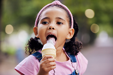 Image showing Young girl, face and eating ice cream in park, outdoor in nature with family day and dessert at picnic. Summer vacation, fun trip and gelato with kid, relax and freedom, travel and adventure mockup