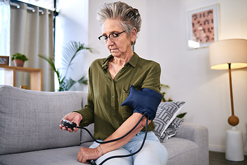 Image showing Healthcare, machine and senior woman with hypertension, health monitor and test for blood pressure. Medicine, check and sick elderly person reading information on a device for a medical problem