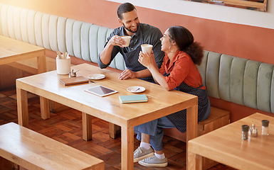 Image showing Coffee, cafe and barista couple at table drinking, talking and laughing at funny meme. Small business, owners or happy man and woman on break with caffeine or espresso while having comic conversation