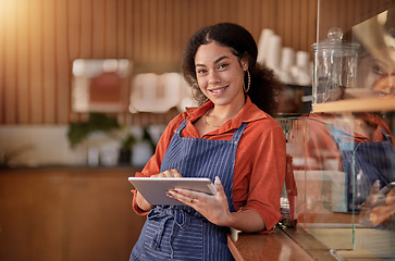 Image showing Portrait, cafe waiter and black woman with tablet to manage orders, inventory and stock. Coffee shop barista, technology and happy female waitress with touchscreen for managing sales in restaurant.