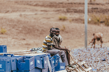 Image showing Truck drivers sitting on spilled cargo, Gondar Ethiopia