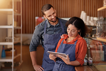 Image showing Restaurant, cafe owner and couple with tablet to manage orders, inventory and stock. Interracial waiters, technology and happy man and woman with digital touchscreen for managing sales in coffee shop