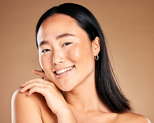 Image showing Portrait, beauty and treatment with a model asian woman in studio on a beige background for natural skincare. Wellness, aesthetic or facial with an attractive young female posing to promote antiaging