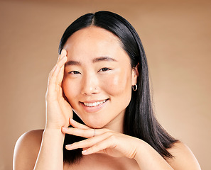 Image showing Portrait, skincare and treatment with a model asian woman in studio on a beige background for natural beauty. Wellness, aesthetic or facial with an attractive young female posing to promote antiaging