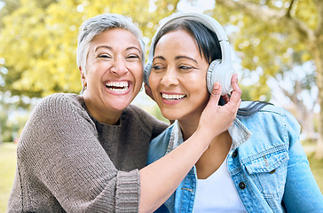 Image showing Music, happy and portrait of women in a park streaming a funny podcast, audio and song in India. Laughing, smile and senior friends with headphones listening to a comic sound or radio in nature