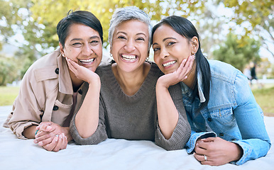 Image showing Portrait, senior women and friends at park on picnic blanket, bonding and enjoying quality time together outdoors. Peace, retirement and happy group of elderly females embrace and relaxing in nature.