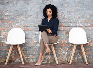 Image showing Recruitment, tablet and woman sitting in line on brick wall for job opportunity, hr email and career networking. Digital technology, waiting room and black person on social media for we are hiring