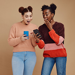 Image showing News, wow and shocked people isolated on studio background for social media, gossip or trendy online sale. Smartphone, surprise notification and gen z friends, black woman reading announcement mockup