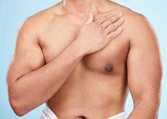 Image showing Skin, body and man after skincare shower or bath for hygiene and wellness isolated against a blue background. Topless, clean and muscles of fit male doing self care cosmetic routine