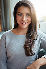 Image showing Beauty, woman and smile portrait of a young person on a home sofa in a living room lounge. Female, happiness and relax feeling of a female on a house sofa with lens flare smiling in a household