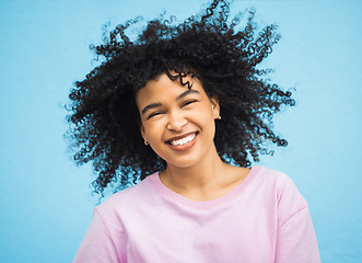 Image showing Shake hair, happy face portrait and black woman with healthy shampoo hairstyle, studio beauty or facial skincare. Cosmetic makeup, spa salon and afro girl from Brazil isolated on blue background wall