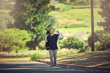 Image showing Rock, carefree and portrait of a man with a skateboard for freedom, fun and urban sport in the street. Happy, trendy and hipster skateboarding in the road for physical activity in nature of Norway