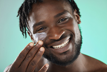 Image showing Skincare, face cream and portrait of a black man in a studio with a beauty, health and natural skin routine. Wellness, cosmetic and African guy with facial spf, lotion or creme by a blue background.