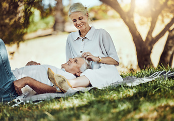 Image showing Retirement, love and picnic with a senior couple outdoor in nature to relax on a green field of grass together. Happy, smile and date with a mature man and woman bonding outside for romance