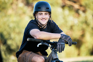 Image showing Portrait, bike and fitness with a sports man taking a break outdoor in nature during his trail ride. Bicycle, exercise and workout with a male athlete training outside for cardio or endurance