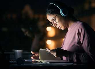 Image showing Headphones, research and girl student studying at night for a test, exam or college assignment. University, notes and woman reading while listening to music, radio or podcast in the evening at a desk