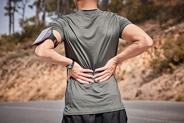 Image showing Fitness, back pain and man in road with hands on hurt muscle for support with smartphone running tracker. Health, exercise and outdoor workout, runner with injury, tension or painful muscles on spine