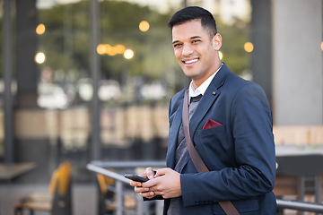 Image showing Phone, portrait and happy businessman in the city with success, leadership and confidence. Technology, mobile and professional corporate manager with a smile networking on a cellphone in the town.