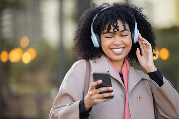 Image showing Black woman, texting and phone in city with headphones, smile and social media chat. Gen z businesswoman, smartphone and online dating with music, podcast or digital networking app in metro