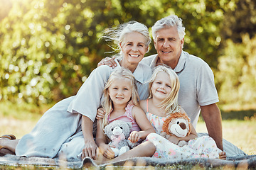 Image showing Grandparents, girl children and family portrait in a outdoor park happy about a picnic. Smile, happiness and kids with elderly grandparent in a garden or backyard smiling from bonding together