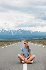 Image showing Woman sitting on the road