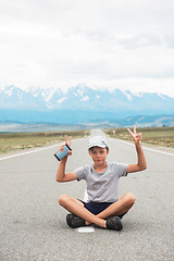 Image showing Woman sitting on the road