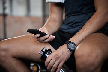 Image showing Fitness, man with phone checking app in gym and break from exercise, planning health goals online. Sports, technology and communication, relax on social media search or reading email on smartphone.