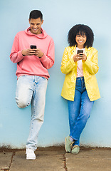 Image showing Happy friends, bonding or phone typing on isolated blue background on social media, couple dating app or city networking. Smile, man or afro woman on mobile technology or community networking website