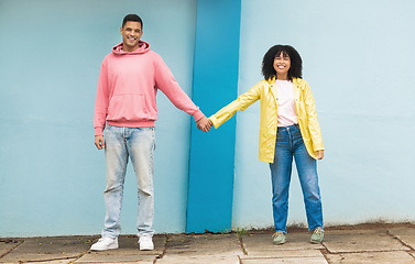 Image showing Happy couple, love portrait and holding hands together for support care, relationship and bonding in urban town. Man, woman smile and partnership hand, romance and solidarity or compassion lifestyle