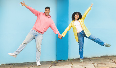 Image showing Happy, smile and happy couple holding hands in the city street doing a silly, fun and goofy pose. Happiness, love and young man and woman with affection standing in a road in town on a walk in Mexico