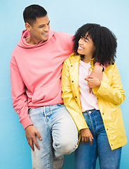 Image showing Couple of friends, bonding and hug on isolated blue background in fashion, afro hair trend and cool style clothes. Smile, happy man and black woman in embrace on wall mock up backdrop in Brazil