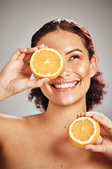 Image showing Orange, beauty and woman face in studio with a smile for natural skin glow, cosmetic and dermatology. Facial results, health and wellness of aesthetic model person happy with vitamin c fruit idea