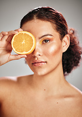 Image showing Woman, orange eye and face portrait in studio for natural skin glow, cosmetics and dermatology. Facial makeup, health and wellness of aesthetic model person with vitamin c skincare fruit results