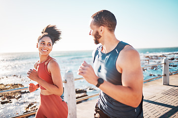 Image showing Running, fitness and sea with a sports couple outdoor during summer for cardio or endurance exercise. Health, training and ocean with a man and woman runner on a promenade for a workout together