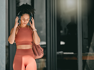 Image showing Fitness, walking and black woman listen to music, relax podcast or radio for calm, stress relief or wellness mockup. Headphones, leaving gym and mock up girl on travel after training workout exercise